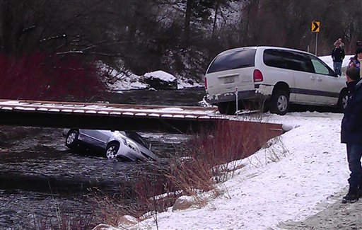 The car is seen in the Logan River in Utah Saturday, Dec. 31, 2011, after it was flipped upright by rescuers who saved three children trapped inside.