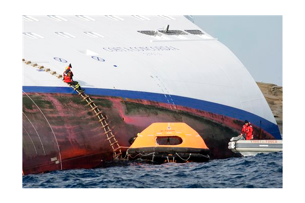 Italian firefighters approach the luxury cruise ship Costa Concordia, which ran aground off the tiny Tuscan island of Giglio, Italy, Sunday, Jan. 15, 2012.