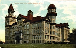 BUFFALO, NY: MARCH 27, 1912 &ndash; Built on Buffalo&rsquo;s highest hill, the massive Masten Park High School could be seen from nearly every part of the city and was known as &ldquo;the school on the hill&rdquo; for its white facade and lofty towers. Around 10 A.M., a fire broke out in one of the towers and the fire gong sounded. The 1,200-strong student body believed it to be a fire drill and marched out onto the cold, slushy grounds only to be surprised to see smoke pouring from the top floors of the castle-like building. As the fire department responded, teachers and students dashed back inside to save musical instruments and a collection of treasured American flags. Further salvage efforts were stopped after a section of the roof collapsed. The school was a total loss, although the library was unharmed and all the books and materials were recovered.