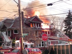 Units of the FDNY 22 Battalion on Staten Island, NY, operate at an early-morning second alarm. Ladder 79 operates its bucket as heavy fire vents through the attic roof. Illegal residents had been vacated from the attic days before the fire. During the fire, firefighters found at least 25 residents within the former single-family dwelling.