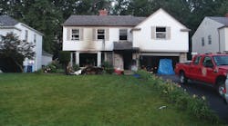 Upon arrival of the first-due engine and truck companies, light smoke was showing from this house and an occupant was leaning out of a second-floor window.