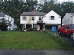 Upon arrival of the first-due engine and truck companies, light smoke was showing from this house and an occupant was leaning out of a second-floor window. Upon arrival of the first-due engine and truck companies, light smoke was showing from this house and an occupant was leaning out of a second-floor window.