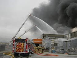 Crews are briefed on the progress of the aerial exterior attack before augmenting the aerial water flow with ground monitors. Crews are briefed on the progress of the aerial exterior attack before augmenting the aerial water flow with ground monitors.