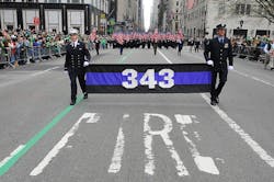 FDNY members carry 343 flags in the St. Patrick&apos;s Day Parade.
