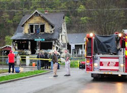 Mayor Danny Jones and Charleston, W.Va., firefighters look over the scene of a house fire on Saturday, March 24. Mayor Danny Jones and Charleston, W.Va., firefighters look over the scene of a house fire on Saturday, March 24.