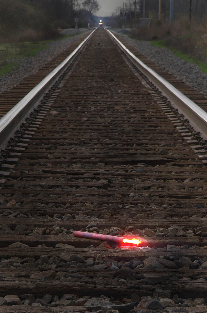 A fuse should be placed on the track at least a mile from the scene.