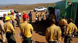 Firefighters receive an update on the Gladiator Fire during a meeting in Cleator, Ariz. on May 17.