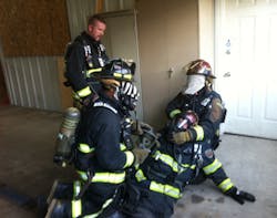 A captain and crew practicing face piece replacement during a company training session. A captain and crew practicing face piece replacement during a company training session.