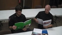 Frederick County, Md., Firefighter/EMTs Jesse Gibson, left, and Tom St. Clair look over EMS documents compiled by the USFA.