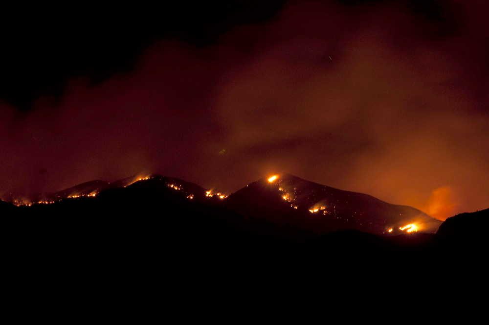 A view of the Gladiator Fire near Crown King, Arizona as shown from the fire operations base camp at Mayer High School in Mayer, Arizona.