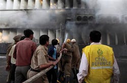 Firefighters spray water after a fire broke out in a multi-story building housing the Punjab National Bank on Parliament Street in New Delhi, India on May 23. Firefighters spray water after a fire broke out in a multi-story building housing the Punjab National Bank on Parliament Street in New Delhi, India on May 23.