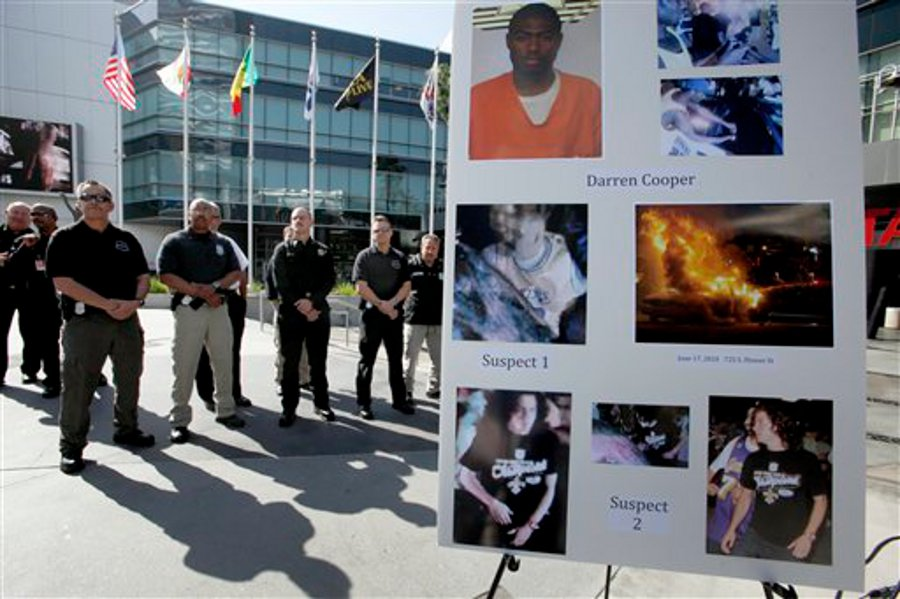 Members of the Los Angeles Fire Department are shown at a news conference on May 9 to announce the arrest of a suspected arsonist following an incident after a Lakers NBA Championship victory in 2010.