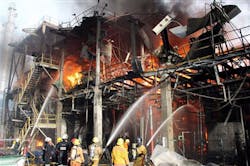 Thai firefighters try to put off the fire after an explosion at a factory in Rayong province on May 5.