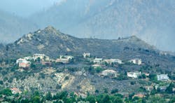 Structures in a development still stand after a wildfire burned through housing subdivisions in the mountains north and west of Colorado Springs, Colo. on June 27. Structures in a development still stand after a wildfire burned through housing subdivisions in the mountains north and west of Colorado Springs, Colo. on June 27.