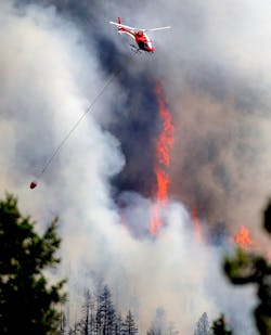 A firefighting helicopter flies above the Flagstaff fire on June 26.