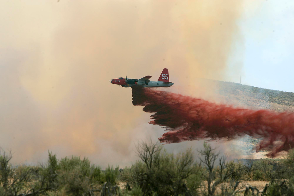A P2V air tanker drops retardant on a wildfire southwest of Elko, Nev. on July 13, 2006.