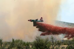 A P2V air tanker drops retardant on a wildfire southwest of Elko, Nev. on July 13, 2006.