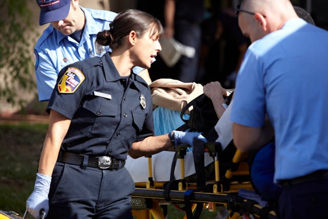CAL FIRE Paramedic Diley Greiser checks on an injured person.