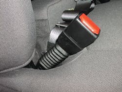 The presence of an accordian-looking sleeve below the seatbelt buckle is a good indicator that the seatbelt pretensioner system is located just below this buckle.