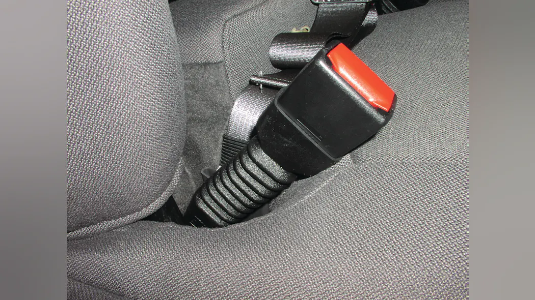 The presence of an accordian-looking sleeve below the seatbelt buckle is a good indicator that the seatbelt pretensioner system is located just below this buckle.