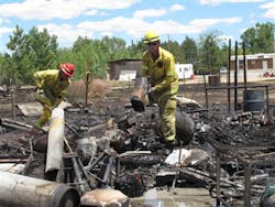 Two firefighters mop up after a small wildfire on the outskirts of Mountain Home, Idaho on June 19. Two firefighters mop up after a small wildfire on the outskirts of Mountain Home, Idaho on June 19.