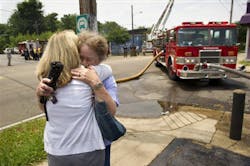 Carol Britton, right, and her daughter Deena Scroggins embrace while across the street as firefighters work to put out a fire that consumed their family-owned business, Mid Continent Laboratories on May 31. Carol Britton, right, and her daughter Deena Scroggins embrace while across the street as firefighters work to put out a fire that consumed their family-owned business, Mid Continent Laboratories on May 31.