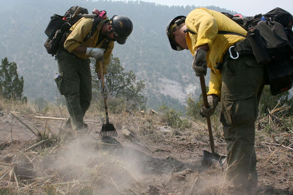 Firefighters from the Granite Mountain Hotshots of Prescott, Ariz., cut a fire line along a mountain ridge outside Mogollon, N.M., on June 2.