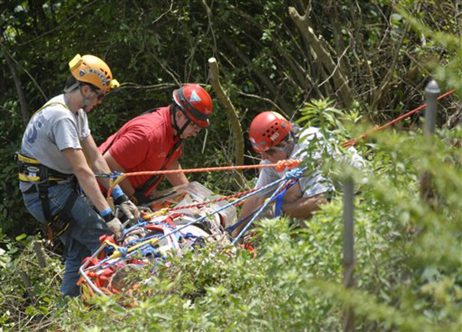 Cody Odom, left, and Patrick Halstead, right, of Walden's Ridge Emergency Services, and Lt. Stuart Ball, center, of Hamilton County Emergency Services lift Mark Bush up over a bluff.