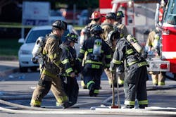 Firefighter work in front of an apartment where the suspect in a theatre shooting lived in Aurora, Colo. on July 20.