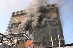 A fire that claimed the lives of two firefighters burns in the former Deutsche Bank building on Aug. 18, 2007.