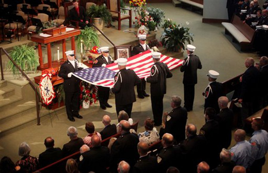 Roanoke Fire and EMS personnel fold the American flag during a memorial service for Boones Mill Firefighter/EMT John Echternach, Jr. on July 7.