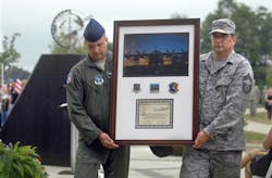 A plaque honoring four North Carolina Air National Guard airmen is unveiled during a memorial service in Charlotte, N.C. on July 10.
