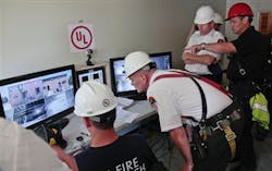 FDNY officials watch live camera feeds from a controlled blaze on Governors Island on July 3.
