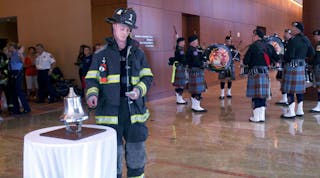 A firefighter rings the bell as he begins the annual National Fallen Firefighters Foundation stair climb at Firehouse Expo.