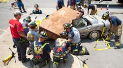 Attendees learn about extrication techniques used during heavy vehicle extrication incidents during hands on training in Columbia.