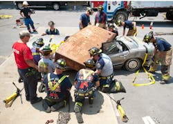 Attendees learn about extrication techniques used during heavy vehicle extrication incidents during hands on training in Columbia.