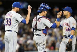 New York Mets reliever Bobby Parnell, left, catcher Mike Nickeas and Andres Torres, right, celebrate their 3-2 win over the Los Angeles Dodgers on June 28.