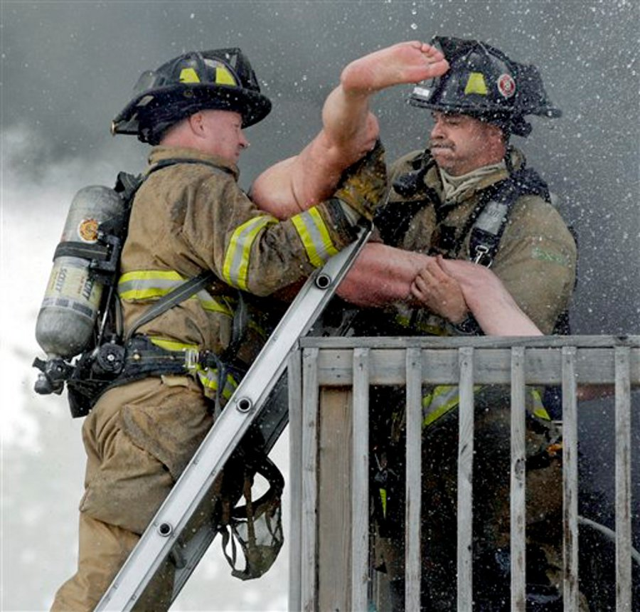 Racine firefighters rescue Pete Lui from the balcony of his burning home on July 24.