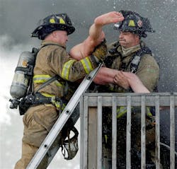 Racine firefighters rescue Pete Lui from the balcony of his burning home on July 24. Racine firefighters rescue Pete Lui from the balcony of his burning home on July 24.