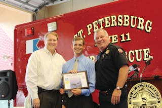 St. Petersburg Mayor Bill Foster (left) and Fire Chief James D. Large (right) presented the Heroic Citizen Award to Gus Hertz.