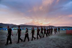 Firefighters from Coeur D&apos;alene, Idaho march to dinner at sunset in the base camp for the High Park wildfire in Fort Collins, Colo. on June 19.