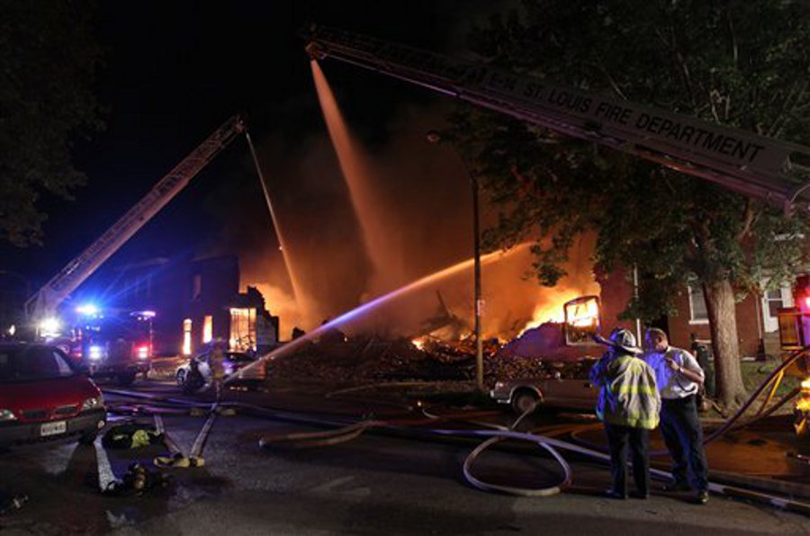 St. Louis firefighters pour water on to a fire in a vacant warehouse on July 26.