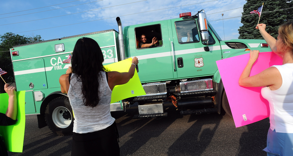 The Colorado Springs community greets firefighters at the workers' fire camp on July 3.