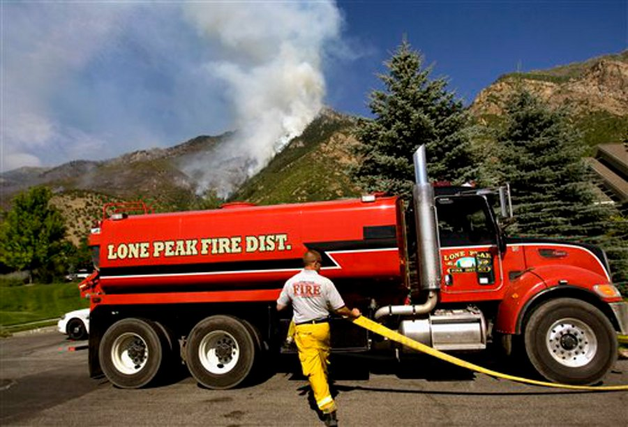 Mike Stevens from Lone Peak Fire fills up a pumper truck with water to battle a wildfire near Alpine, Utah on July 4.