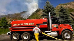 Mike Stevens from Lone Peak Fire fills up a pumper truck with water to battle a wildfire near Alpine, Utah on July 4.
