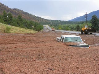 A pickup truck is engulfed by a mudslide on U.S. 24 west of Cascade, Colo. on July 30.