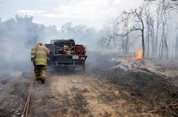 A firefighter works to battle a wildfire just west of Mannford, Okla. on Aug. 5. A firefighter works to battle a wildfire just west of Mannford, Okla. on Aug. 5.