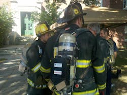 A firefighter location transmitter is fitted to a Worcester firefighter during a technology workshop at Worcester Polytechnic Institute on Aug. 7.