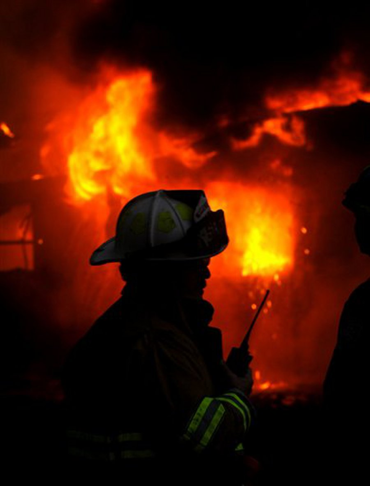 Firefighters work at the scene of a fire at Patterson Funeral Home in Shreveport, La. on Aug. 15.