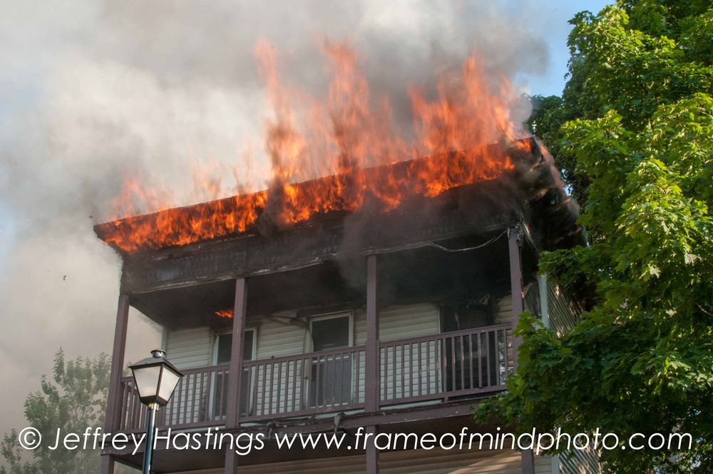 Flames tore through three multi-family buildings in Manchester, N.H. on Aug. 13 as approximately 100 firefighters battled to keep the blaze from spreading.